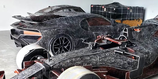 Chiron-inspired full-scale recycled metal hypercar — rear three-quarter view in the fabrication studio