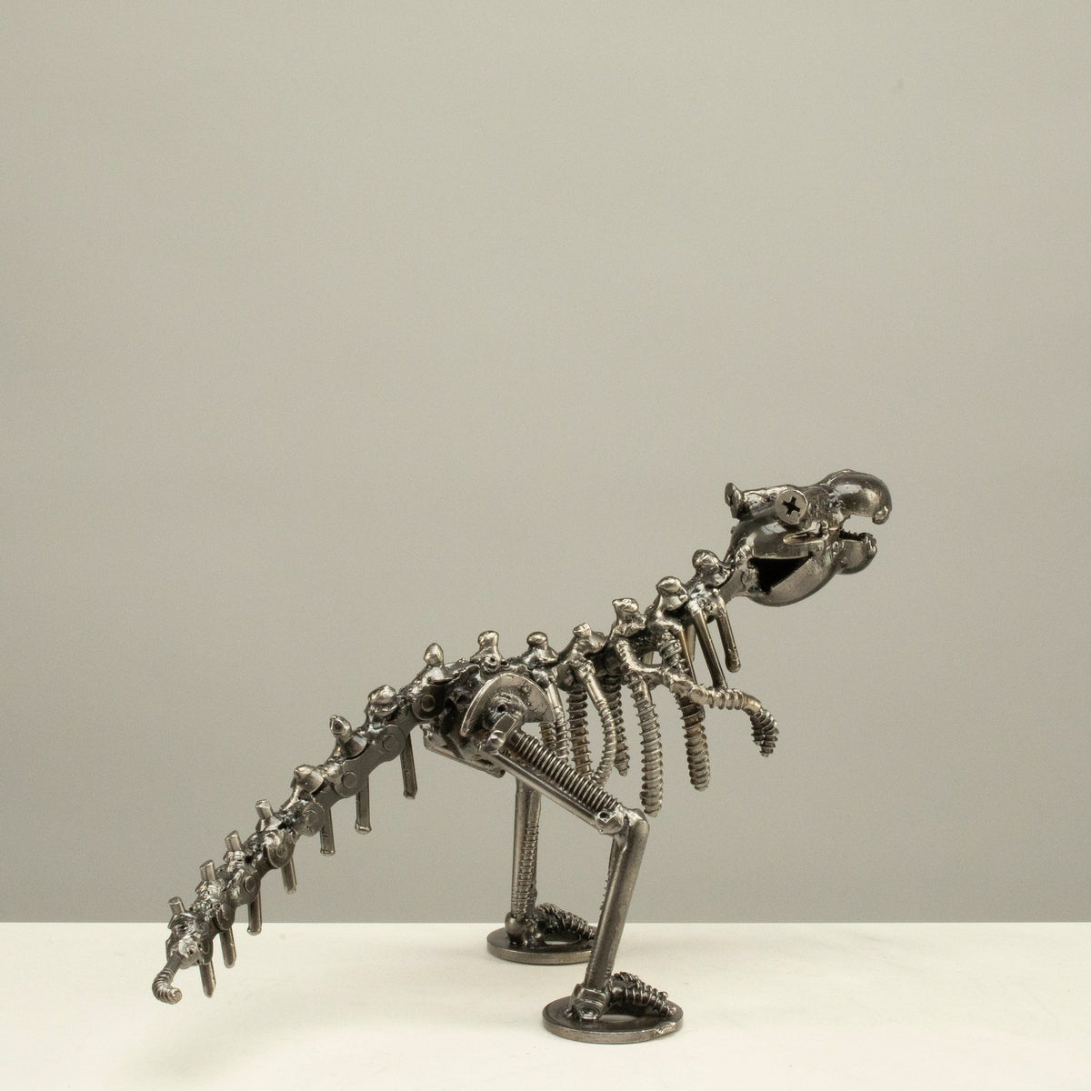 T-Rex metal sculpture side profile — Vault 88