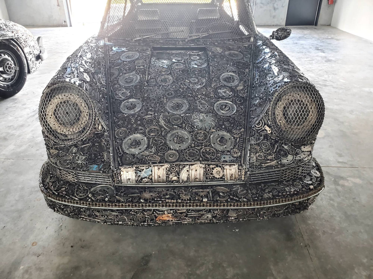 Carrera RS inspired full-scale classic recycled metal sculpture, front view with mesh headlights
