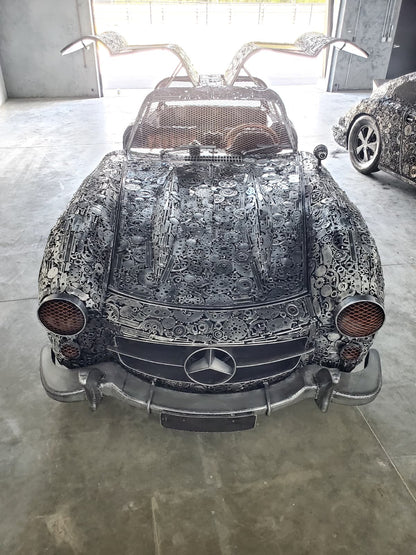 Gullwing-inspired full-scale coupe recycled metal sculpture with doors raised, front view