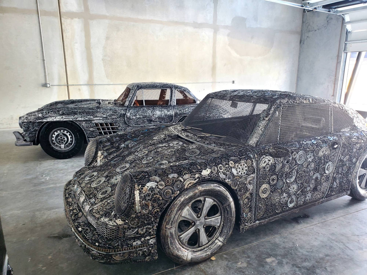 Gullwing-inspired full-scale coupe recycled metal sculpture displayed in the workshop