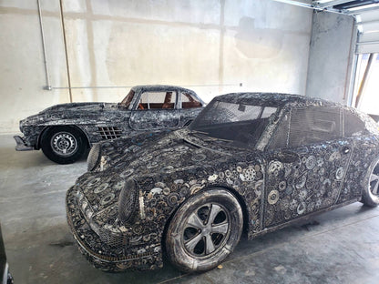 Gullwing-inspired full-scale coupe recycled metal sculpture displayed in the workshop